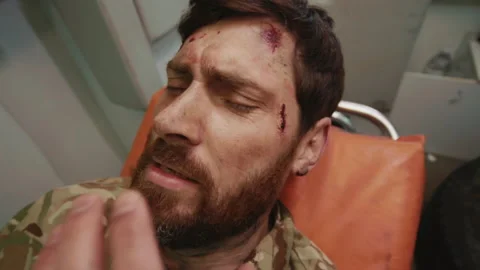 Close-up shot of man in uniform lying on hospital emergency transport vehicle in Stock Footage 192987192