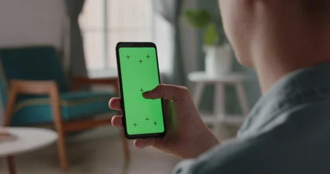 Close up shot of a man using smartphone with chroma key green screen, scrolling Stock Footage 133526591