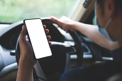 Close up shot of man using smartphone in car.. Foto stock