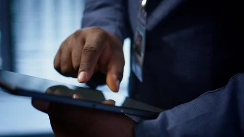 Close up shot of man using tablet in data center, ensuring rigs are functioning Stock Photos