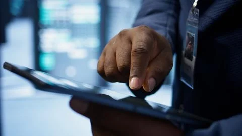 Close up shot of man using tablet in data center, ensuring rigs are functioning 写真素材
