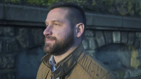 Close shot of man, walking along the wall, steadicam  Vídeo Stock 72775596