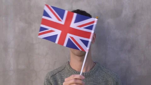 Close up shot of a man waving British flag in slow motion. United Kingdom Stock Footage 336525570
