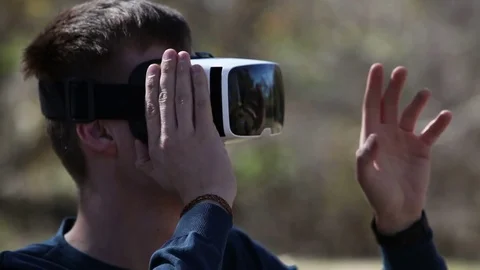 Close-up shot of a man wearing virtual reality goggles outdoor Stock Footage 73580020
