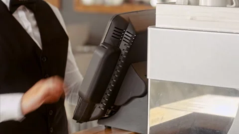 Close up shot of manager swiping touch payment terminal as waitress picking up t Stock Footage 199633827