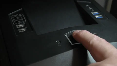 Close-up shot of a man's finger pressing the power button on a computer case Stock Footage 263775461