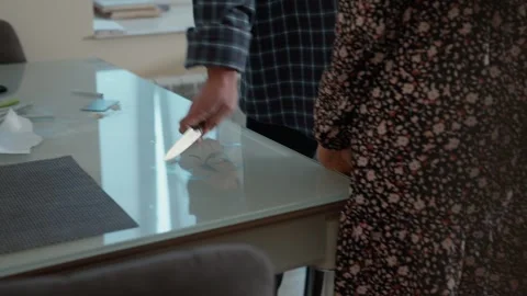 A close-up shot of a mans hand grabbing a knife lying on the table the scene is 스톡 동영상 321199018