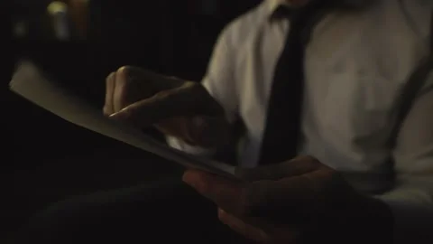 A close-up shot of a man's hand, holding papers, documents, a contract. Stock Footage 235352298