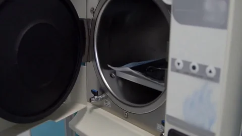 Close up shot of the man's hand open the door of sterilized dental apparatus Stock Footage 73458058
