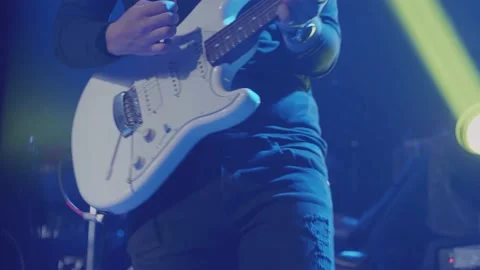 Close-up shot of a man's hand playing an electric guitar on stage. Stock Footage 144539558