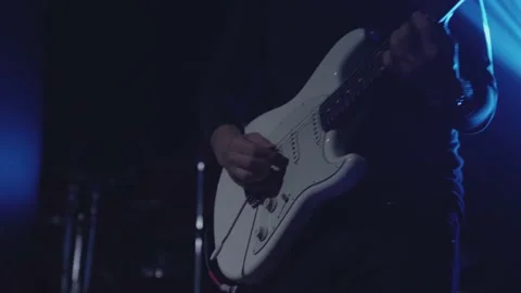 Close-up shot of a man's hand playing an electric guitar on stage. Stock Footage 144539560