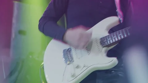 Close-up shot of a man's hand playing an electric guitar on stage. 動画素材 144539603