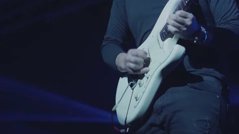 Close-up shot of a man's hand playing an electric guitar on stage. Stock Footage 145125584