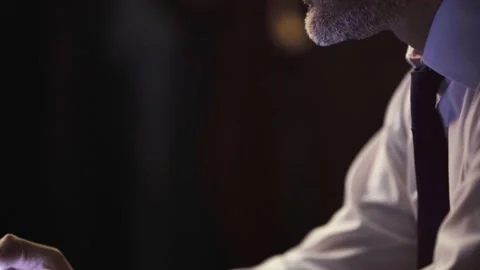 In the close-up shot, the man's hands are holding the phone, typing. Stock Footage 235351998