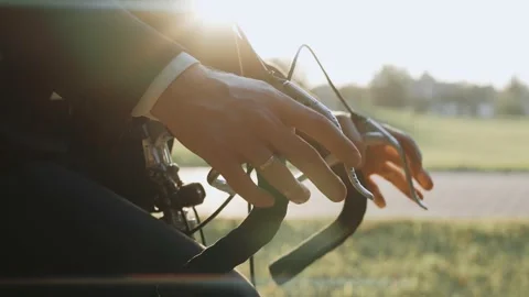Close-up shot of man's hands on the handlebars of a bike at the park Video stock 163350694
