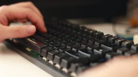 Close up shot of a man’s hands interacting with an rgb keyboard in a dirty Stock Footage 236622592