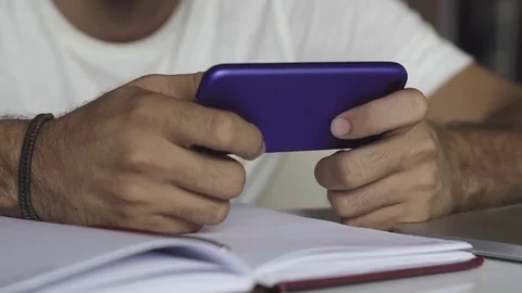 Close up shot of man's hands playing game on smartphone Video stock 83189547