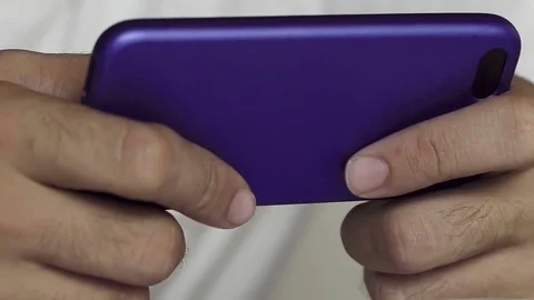 Close up shot of man's hands playing game on smartphone Stock Footage 83189644