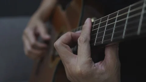 Close-up shot of a man's hands playing a classical guitar. Stock Footage 128241520