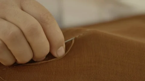 Close up shot on man's hands' sewing to Saudi outfit Stock Footage 113665457