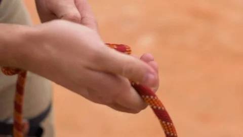 Close-Up Shot Of Man's Hands Tying A Knot With A Rope Stock Footage 78992199