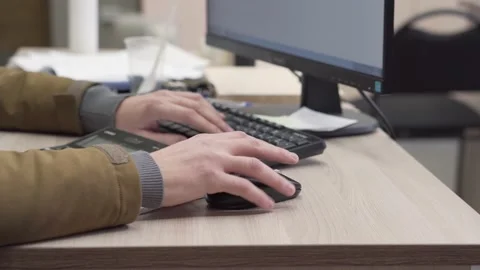 Close-up shot of man's hands typing on a computer keyboard. Video stock 150315253