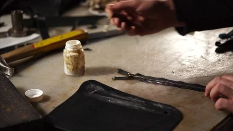 Close up shot of man's hands, who smears glue detail from the handmade products Stock Footage 83139998