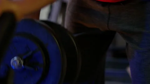 Close shot of man's legs doing "one hand rowing" musculation exercise. Stock Footage 142121123