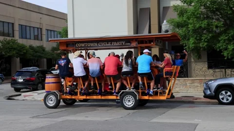 Close up shot of many people playing Cowtown Cycle Party car Stock Footage 201315140