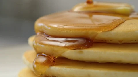 Close-up shot of maple syrup pouring over pancakes.  Shot with RED 8K camera. Stock Footage 130354256