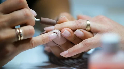 Close-up shot of master uses an electric machine to remove the nail polish du Stock Footage 123504222