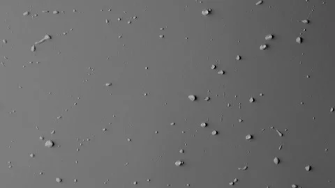 Close up shot of matte glass on the grey background. Reverse shot of water drops Stock Footage 259639660