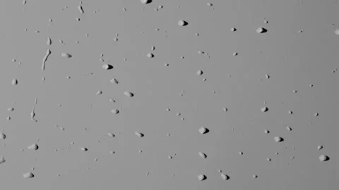Close up shot of matte glass on the grey background. Reverse shot of water drops Stock Footage 259639685