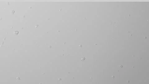 Close up shot of matte glass on the grey background. Reverse shot of water drops Stock Footage 259639776