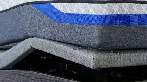 Close-Up Shot Of Mattress Lowering On Adjustable Base Stockbeeldmateriaal 76377294