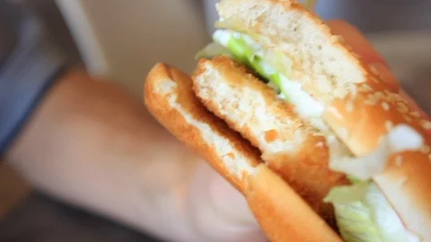 A close-up shot of a McDonalds vegetarian chicken burger. A bite has been Stock Footage 99357337