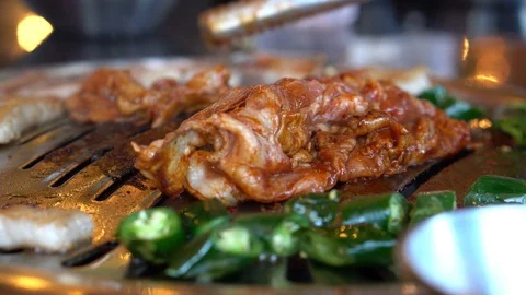 Close up shot of men hand cooking korean grilled pork belly Stock Footage