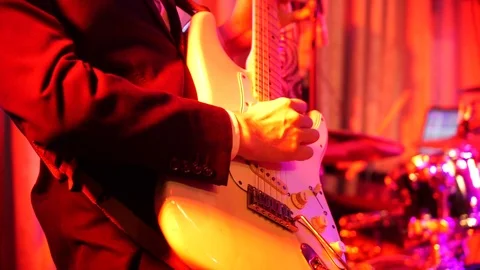 Close up shot of men playing electric guitar on stage at night Stock Footage 111346444