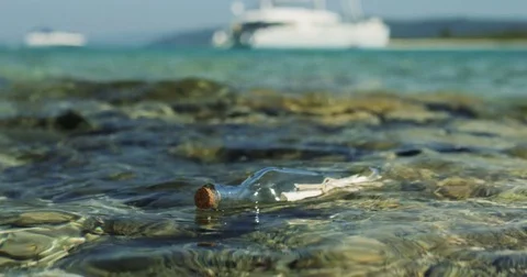 Close-up Shot of a Message in the Bottle, Drifting in Shallow Seas. Stock Footage 81540303