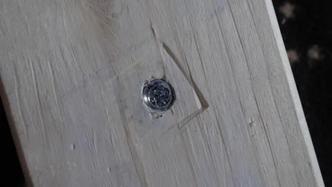 Close-up shot of a metal screw securing planks of wood together Stock Footage 290766274