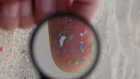 Close up shot of microplastics in hands vertical video. micro plastics in sand Stock Footage 220734079