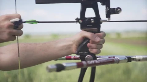 Close up shot of middle age man archer with strong hands bending mechanic bow ar Stockbeeldmateriaal 132675836