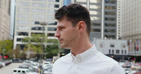A close-up shot of a middle-aged man in a white shirt standing focused and Stock-Footage 347023802
