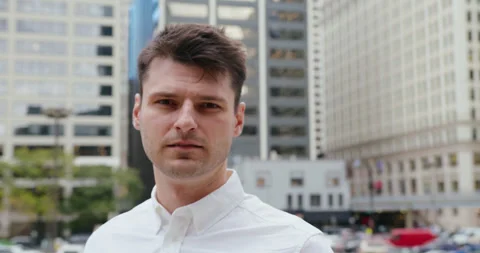 A close-up shot of a middle-aged man in a white shirt standing focused and 動画素材 347023839
