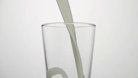 Close-up shot of milk pouring into empty glass Stock Footage 75954677