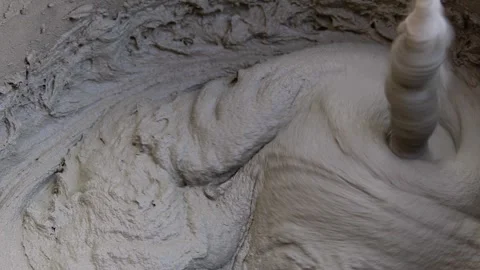 Close-up shot of mixing cement mortar for tiles. Stock Footage 246012943