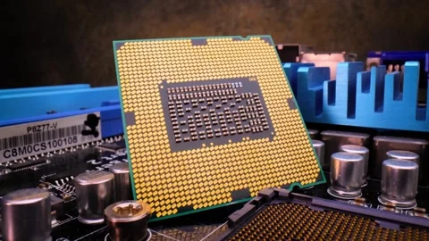 A close-up shot of a modern CPU with golden pins on a black motherboard, ca.. Stock Footage 337337240