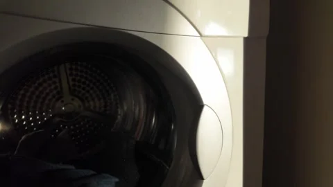 Close-Up Shot of Modern Washing Machine with Laundry Inside Stock Footage 263412503