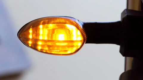 Close shot of a motorcycle blinking and indicating to take a turn Stock Footage 145361813
