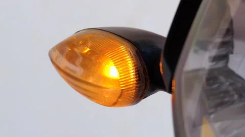 Close shot of a motorcycle blinking and indicating to take a turn Stock Footage 145362246